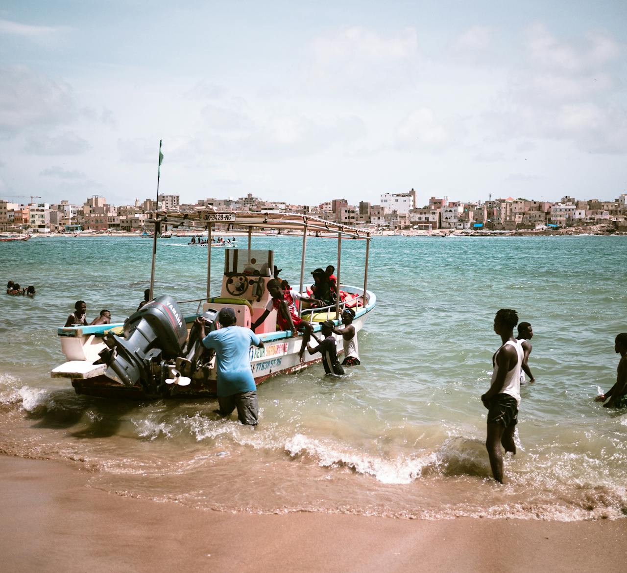Fishermen bring in their catch near the shore of a vibrant Senegalese coast.